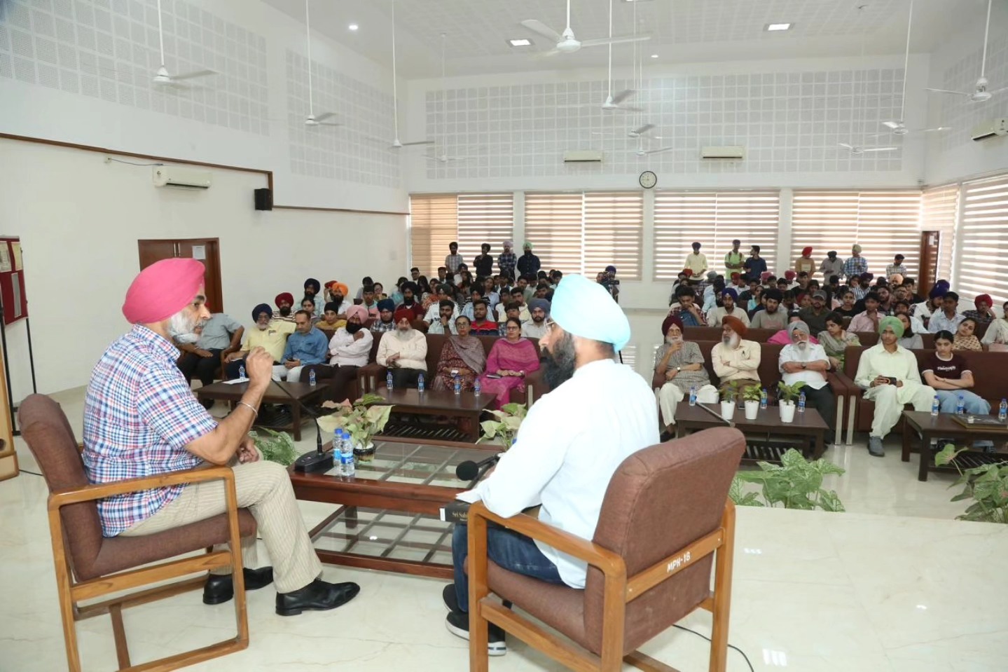 S. Gurbir Singh shares insights while responding to S. Gurshamshir Singh during the discussion, in the presence of management, Principal, faculty and students.